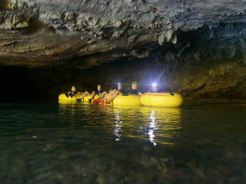 Cave tubing takes participants on drifts through underground rivers.