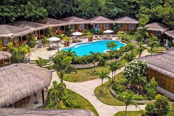 Resort bungalows cluster around the swimming pool. Resort bungalows cluster around the swimming pool.